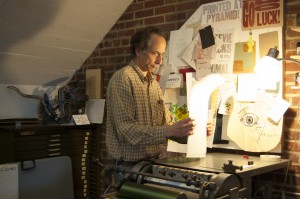 Letterpressing Amichai -- Rick Black jogs paper and "packing" together