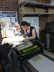 Laura Kinneberg looking over a print.